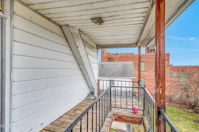 a view of balcony with wooden floor and fence