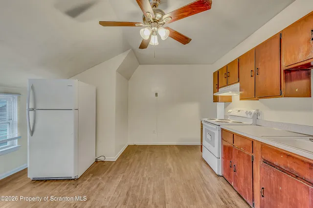 a kitchen with a stove a refrigerator and a sink