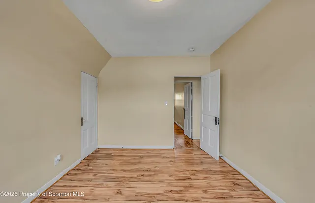 a view of a room with wooden floor and bathroom