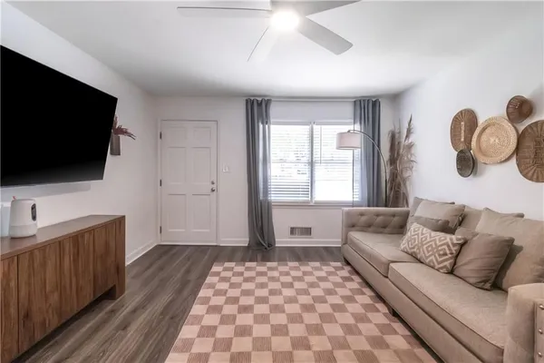 a living room with furniture and a flat screen tv