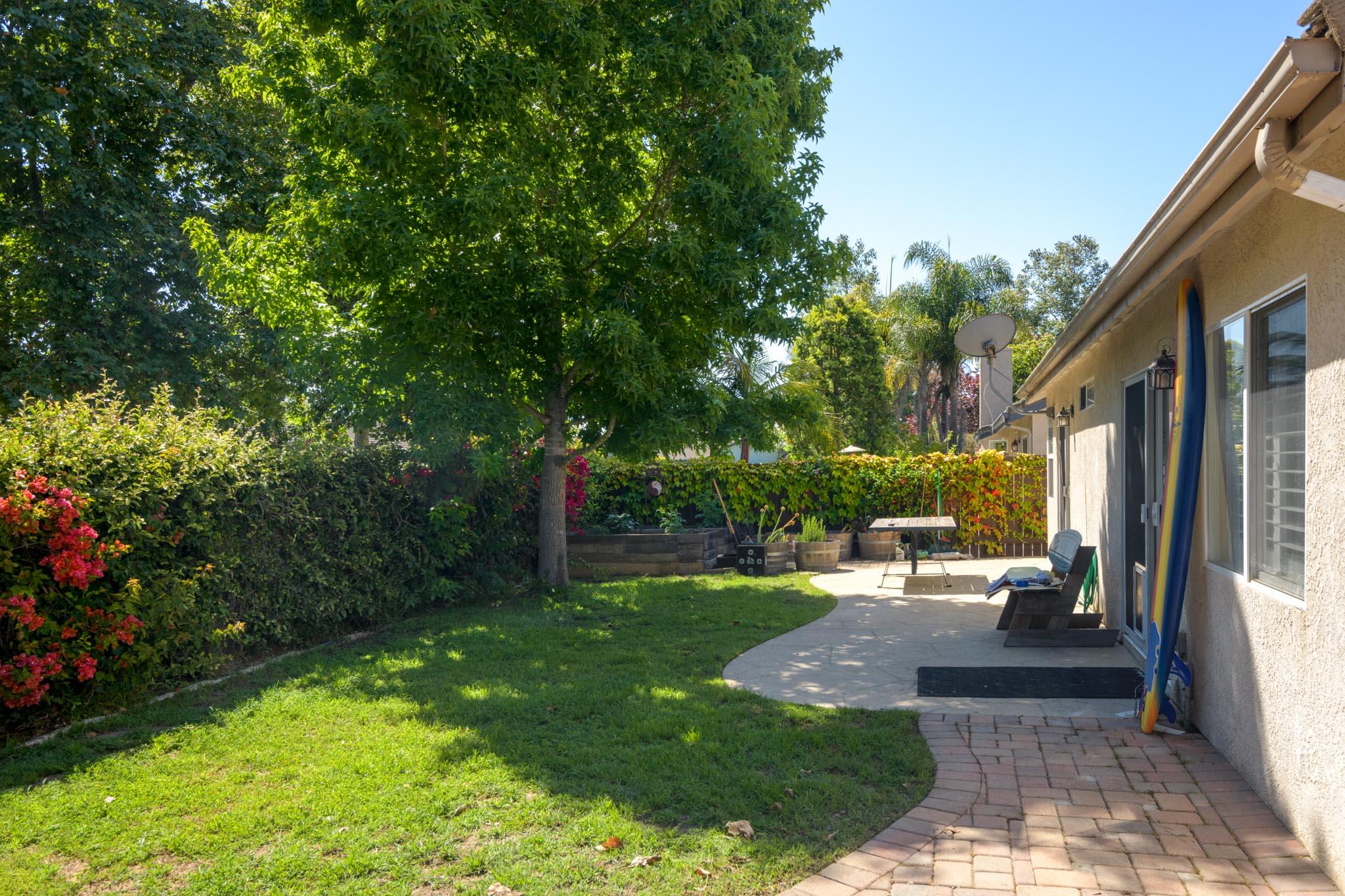 128 Gerard Drive Goleta, CA 93117 - Photo 13 of 20 a view of a patio with table and chairs potted plants and large tree