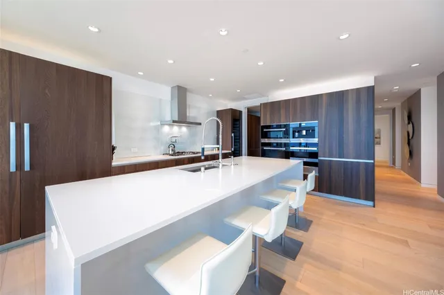 a large kitchen with a large counter top appliances and cabinets