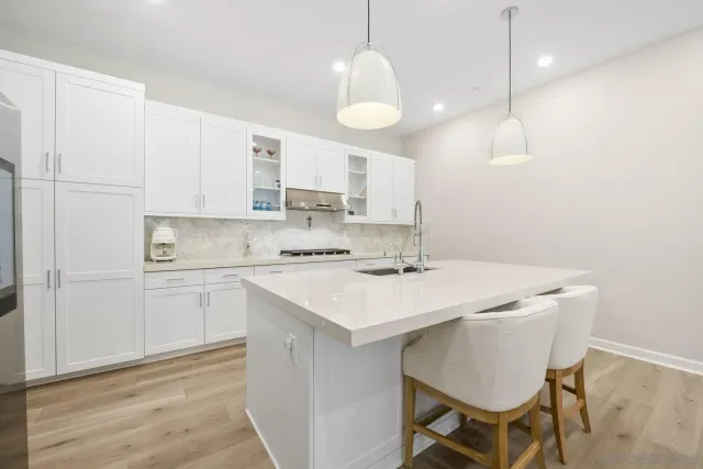 a kitchen with a sink cabinets and wooden floor