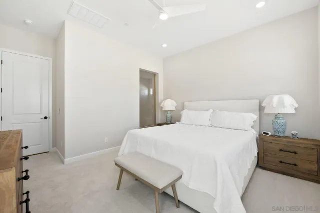 a bedroom with a bed and a lamp on table