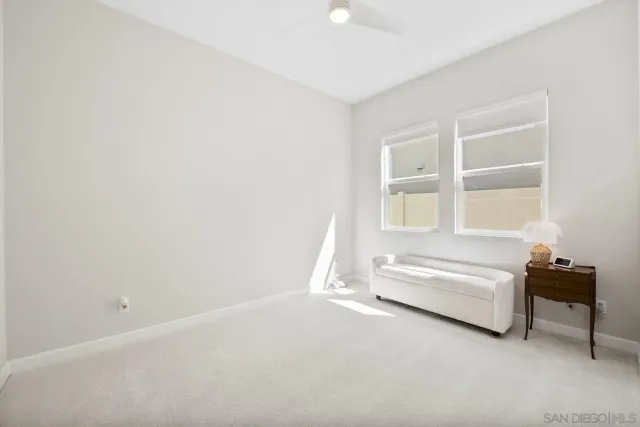 a spacious bedroom with a bed and a window
