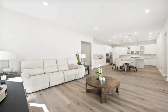 a living room with furniture and view of kitchen