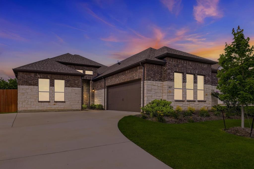 Contemporary single-story residence featuring a brick and stone facade