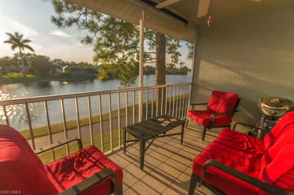 a view of a chairs and table in the balcony