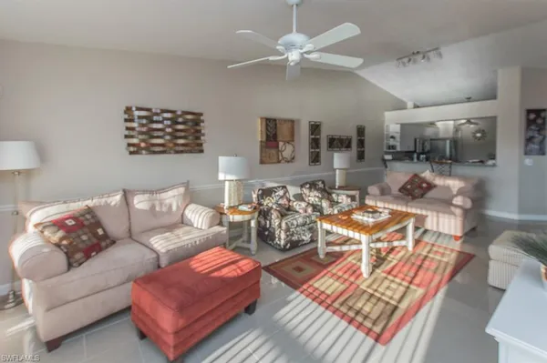 a living room with furniture a rug and a chandelier
