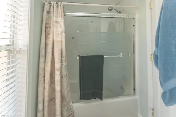 a bathroom with a glass shower door