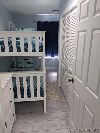 a bedroom with a bed and flat screen tv