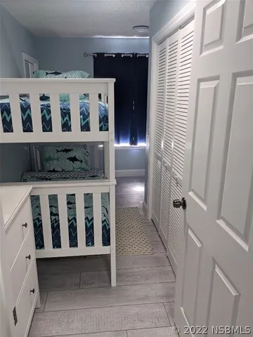 a bedroom with a bed and flat screen tv