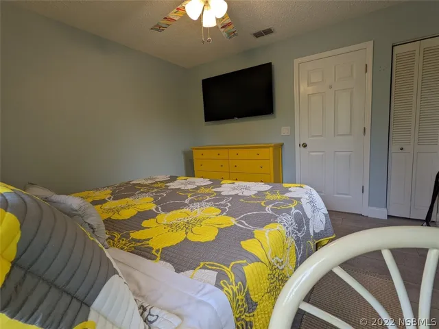 a bedroom with a bed and a flat tv screen