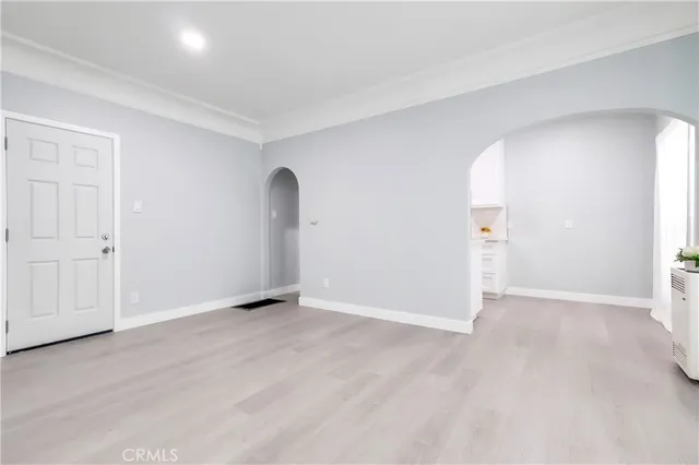 an empty room with wooden floor