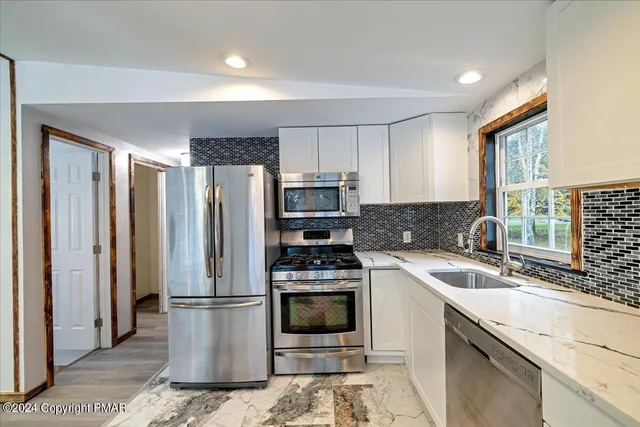 an empty room with wooden floor and window