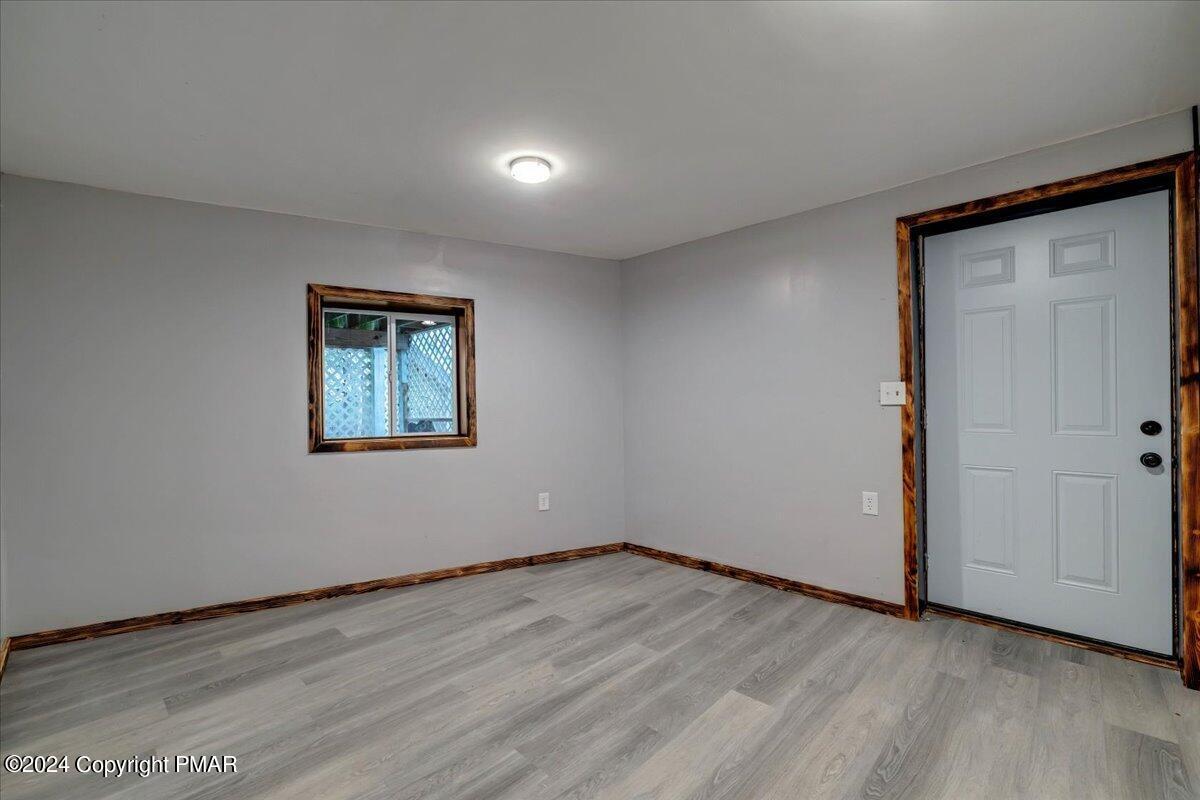 1456 Allegheny Drive Blakeslee, PA 18610 - Photo 28 of 94 an empty room with wooden floor and windows