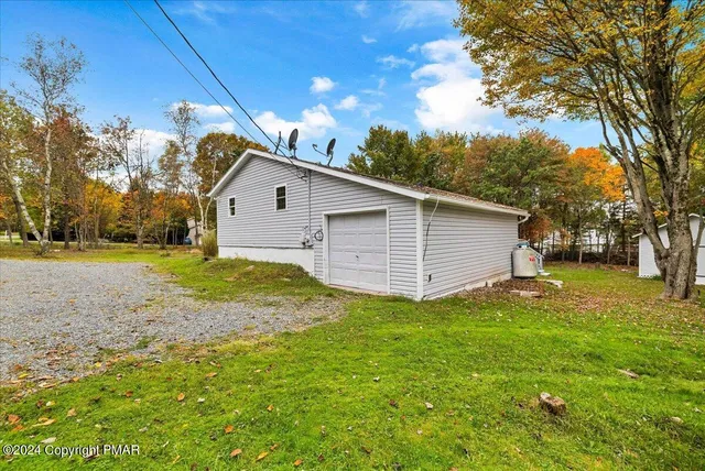 a view of a backyard with large tree