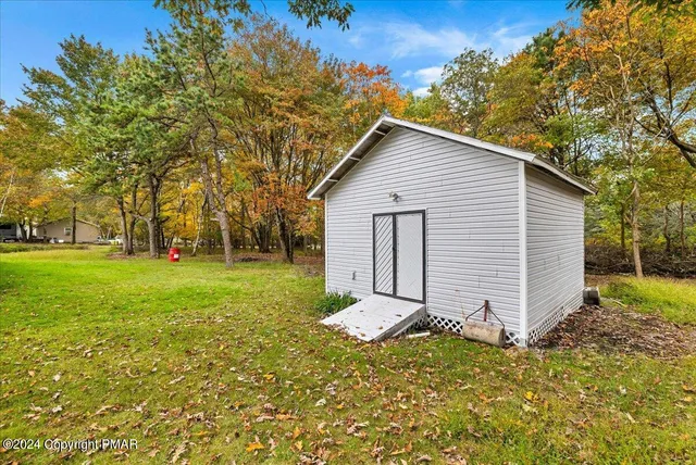 an aerial view of a house with a yard table and chairs