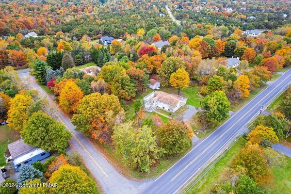 a kitchen with stainless steel appliances kitchen island granite countertop a refrigerator a stove and a sink with granite countertops