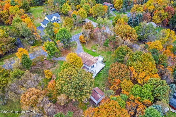 an empty room with wooden floor and window