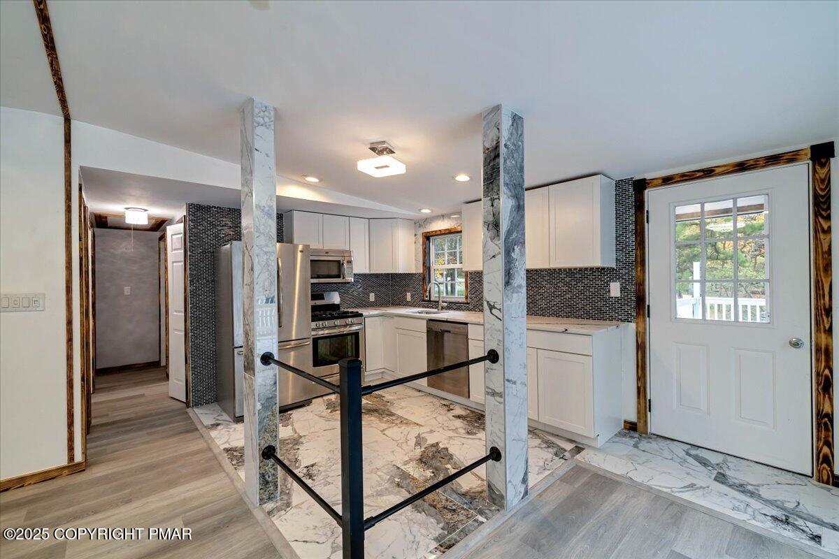 1456 Allegheny Drive Blakeslee, PA 18610 - Photo 77 of 94 a kitchen with stainless steel appliances kitchen island granite countertop a refrigerator a stove and a sink with granite countertops