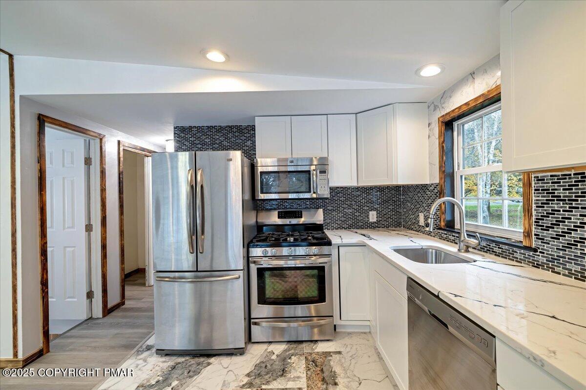 1456 Allegheny Drive Blakeslee, PA 18610 - Photo 78 of 94 a kitchen with a refrigerator a stove a sink and a cabinets