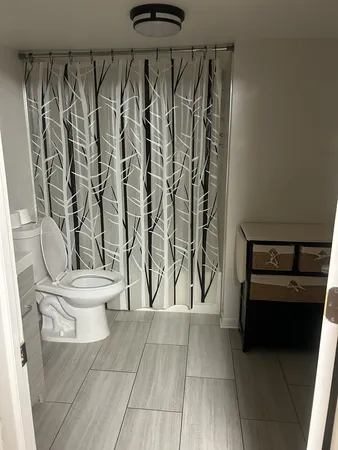 a bathroom with a toilet and a shower