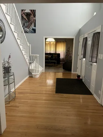 a living room with furniture floor to ceiling window and hardwood floor
