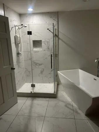 a bathroom with a tub and a shower