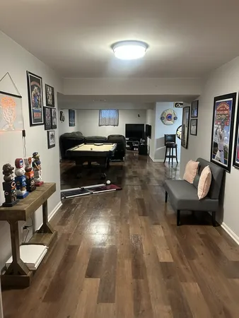 a living room with furniture and a wooden floor
