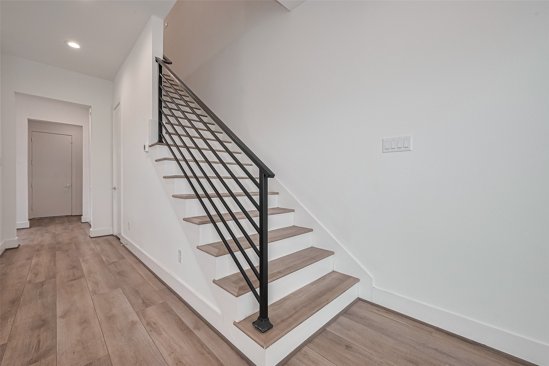 3510 Hadley Street Houston, TX 77004 - Photo 19 of 48 The staircase unites style and structure with rich wood treads that echo the flooring below. A matte black handrail adds a bold contrast and contemporary edge.