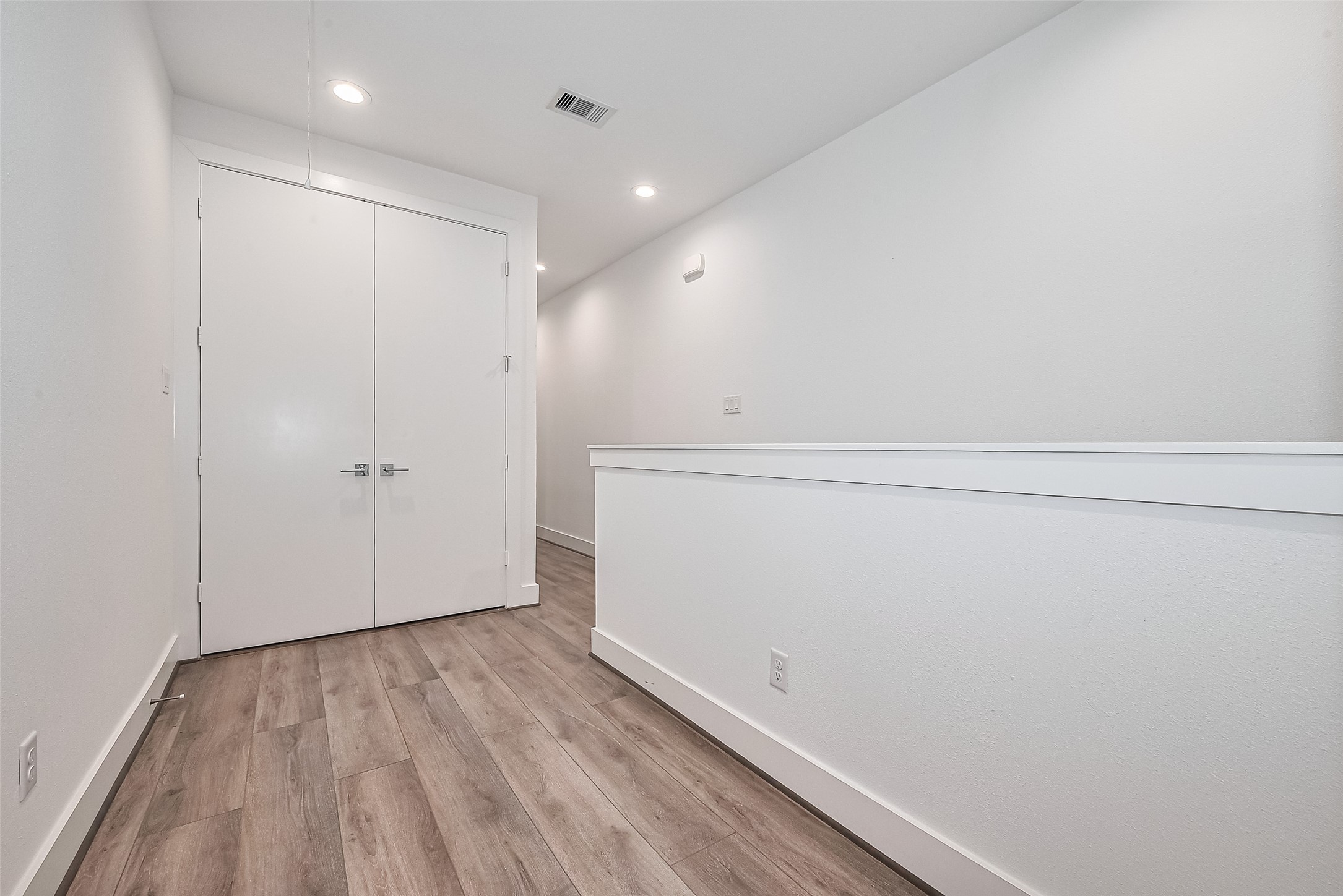 3510 Hadley Street Houston, TX 77004 - Photo 23 of 48 The upstairs landing offers a central transition point to the private quarters, lit by clean recessed lighting and framed by the continuation of sleek design elements.