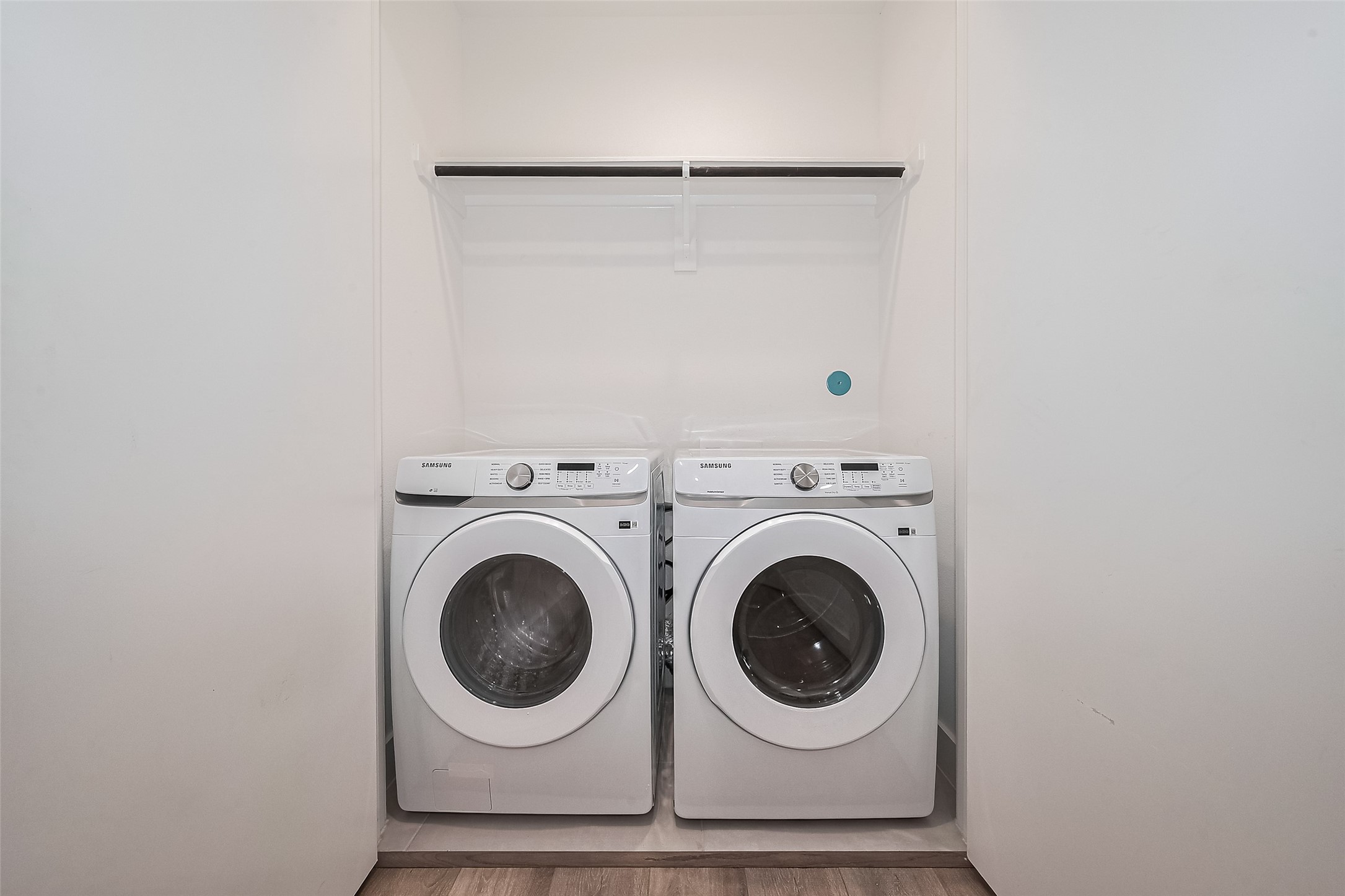 3510 Hadley Street Houston, TX 77004 - Photo 25 of 48 The laundry room is well-lit and thoughtfully outfitted with a hanging rod and built-in storage for ease.