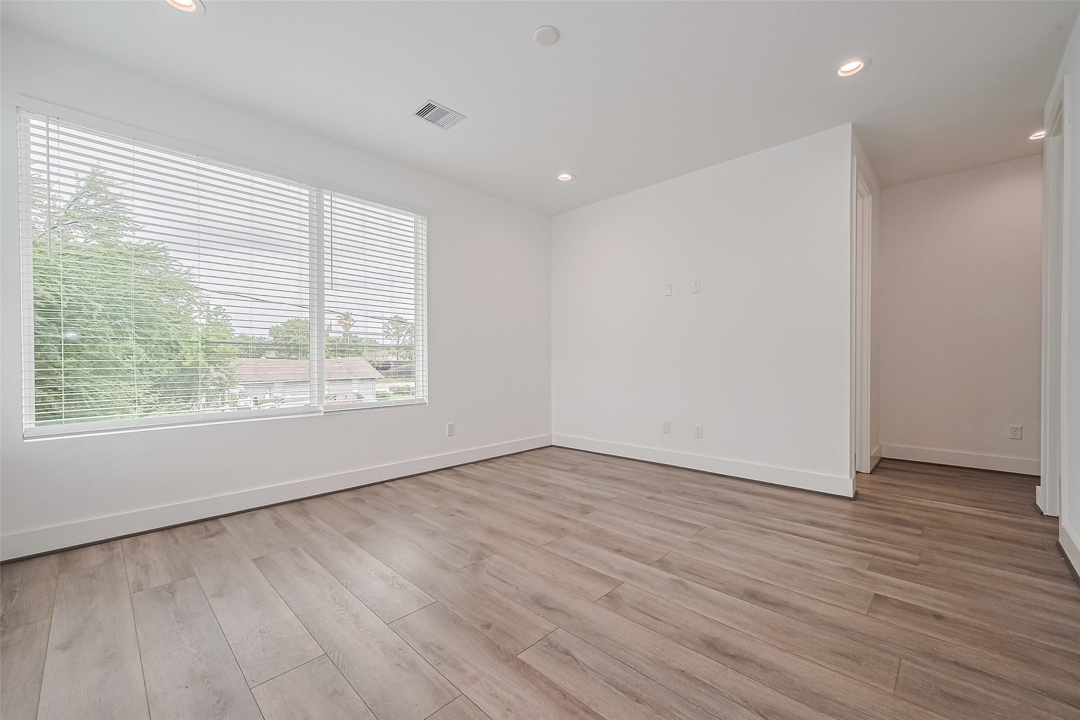 3510 Hadley Street Houston, TX 77004 - Photo 32 of 48 a view of an empty room with wooden floor and a window