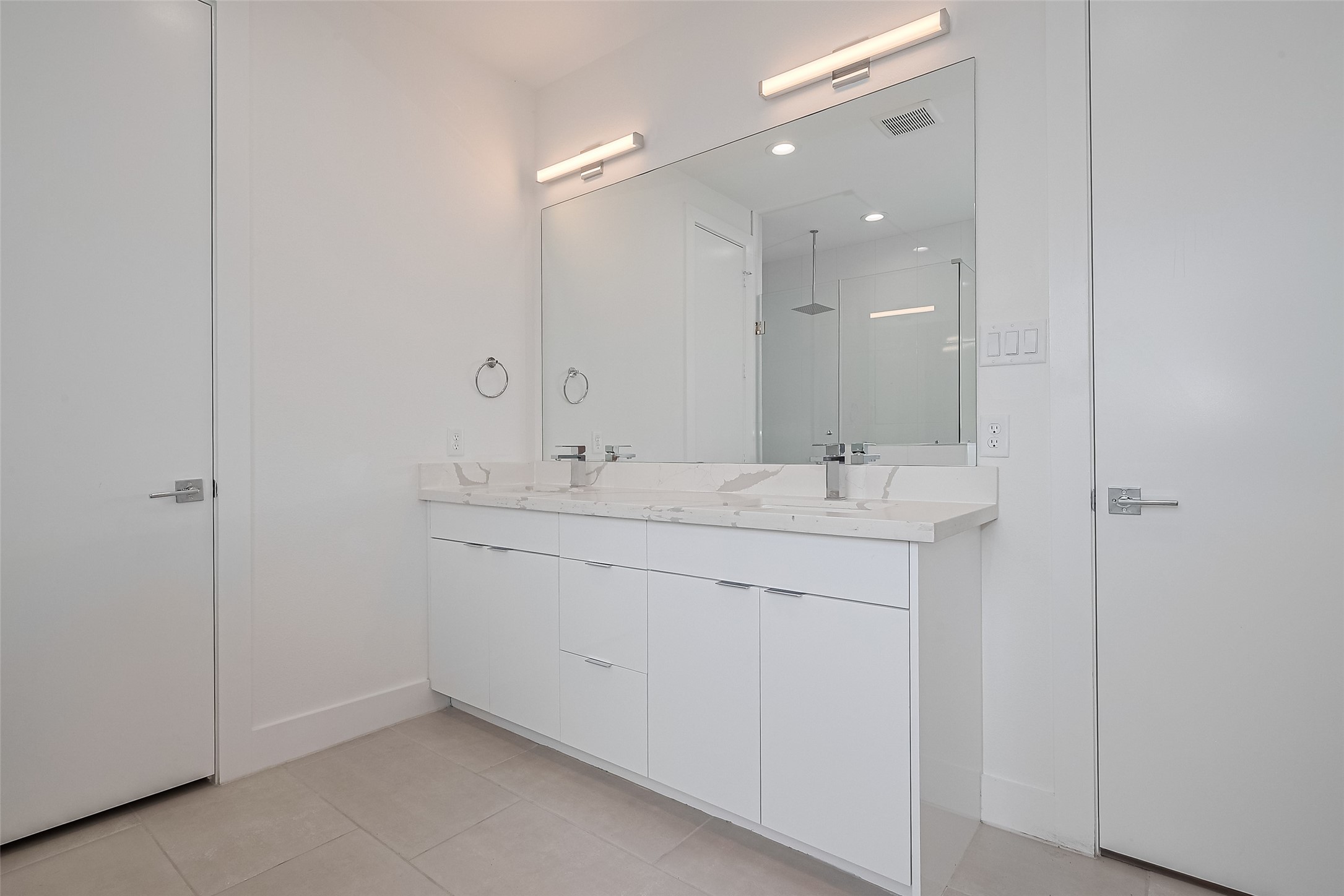 3510 Hadley Street Houston, TX 77004 - Photo 43 of 48 a bathroom with a double vanity sink and a mirror