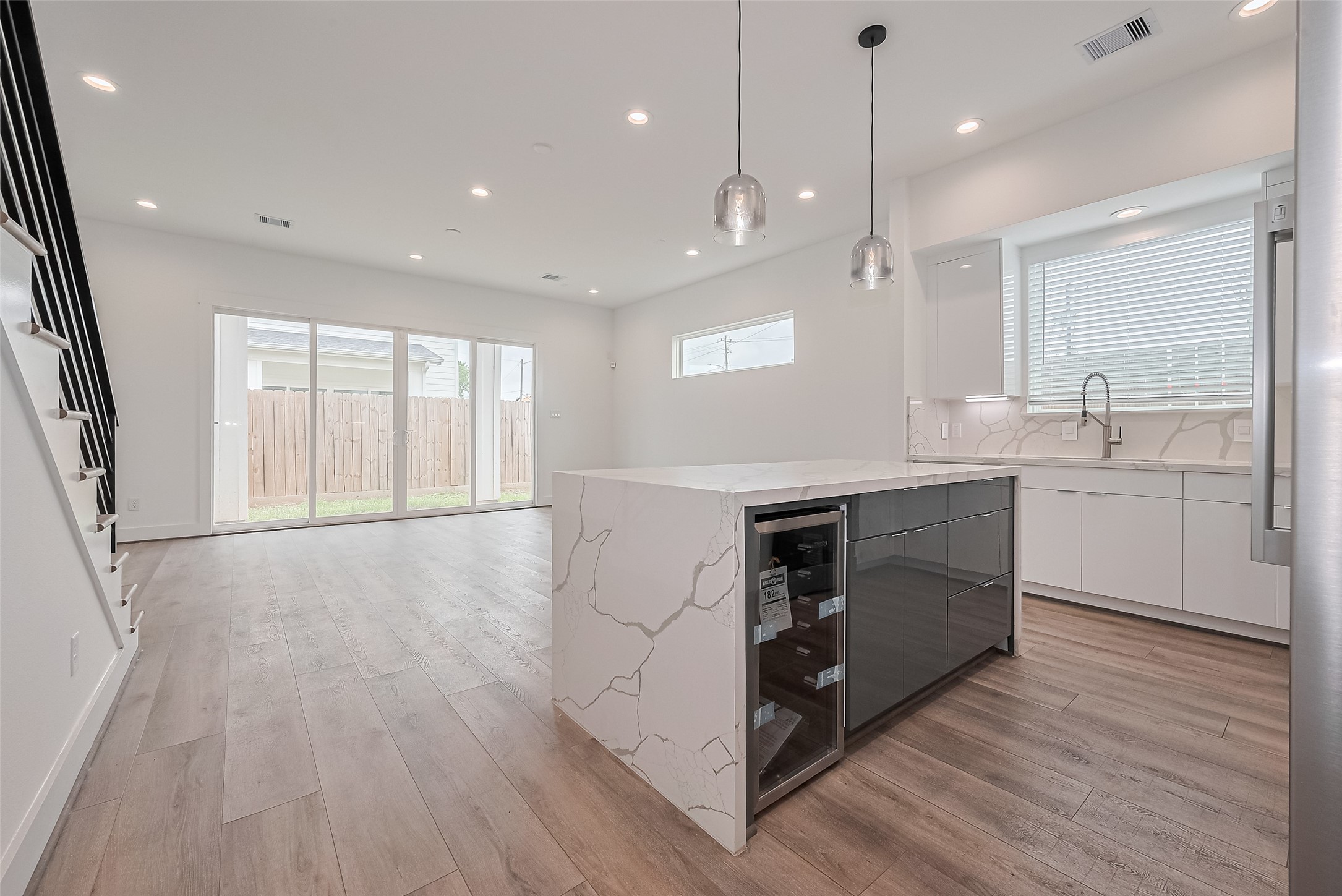 3510 Hadley Street Houston, TX 77004 - Photo 9 of 48 The kitchen and living space flow seamlessly in an airy open-concept design, with the island providing a gentle division.