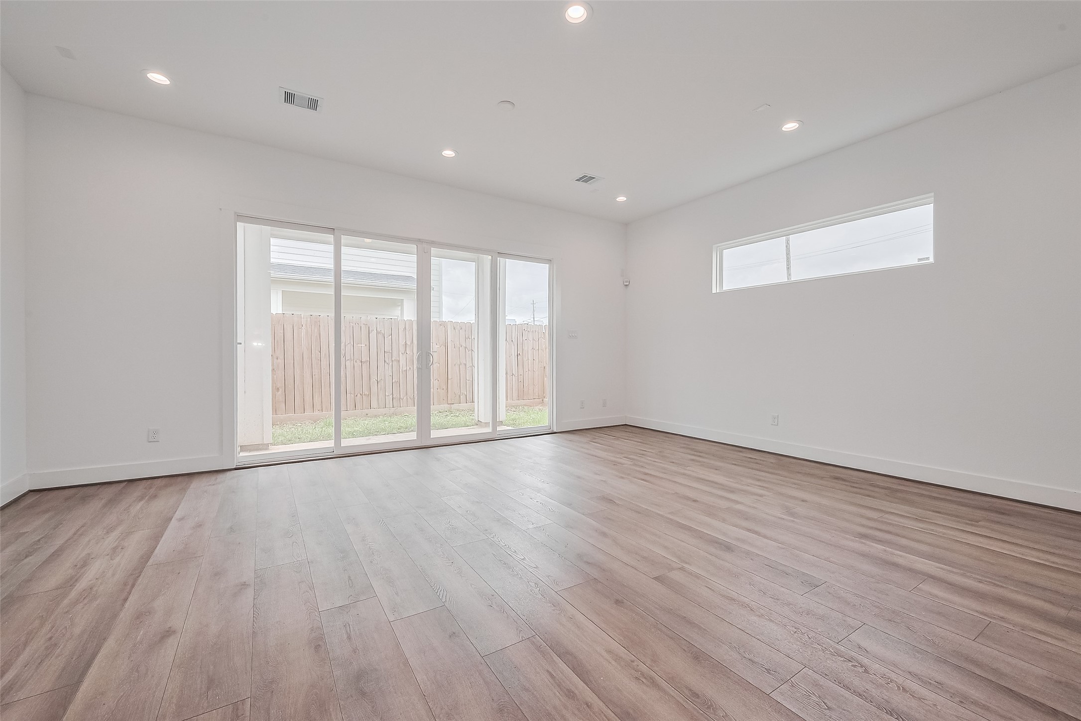 3510 Hadley Street Houston, TX 77004 - Photo 10 of 48 a view of an empty room with wooden floor and a window