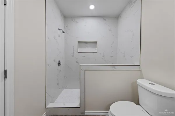 a bathroom with a toilet sink and vanity