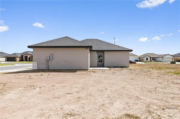 a view of a house with a backyard
