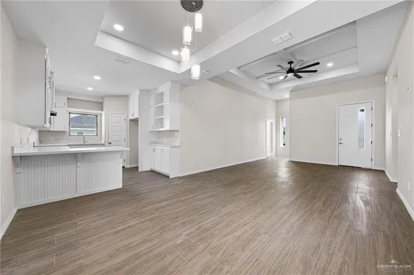 a kitchen with white cabinets and sink