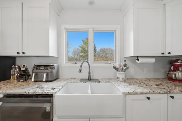 a kitchen with granite countertop a sink and a stove