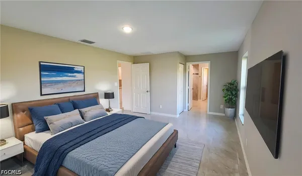 a bedroom with a bed and a couch