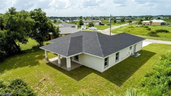 an aerial view of a house with swimming pool and ocean view