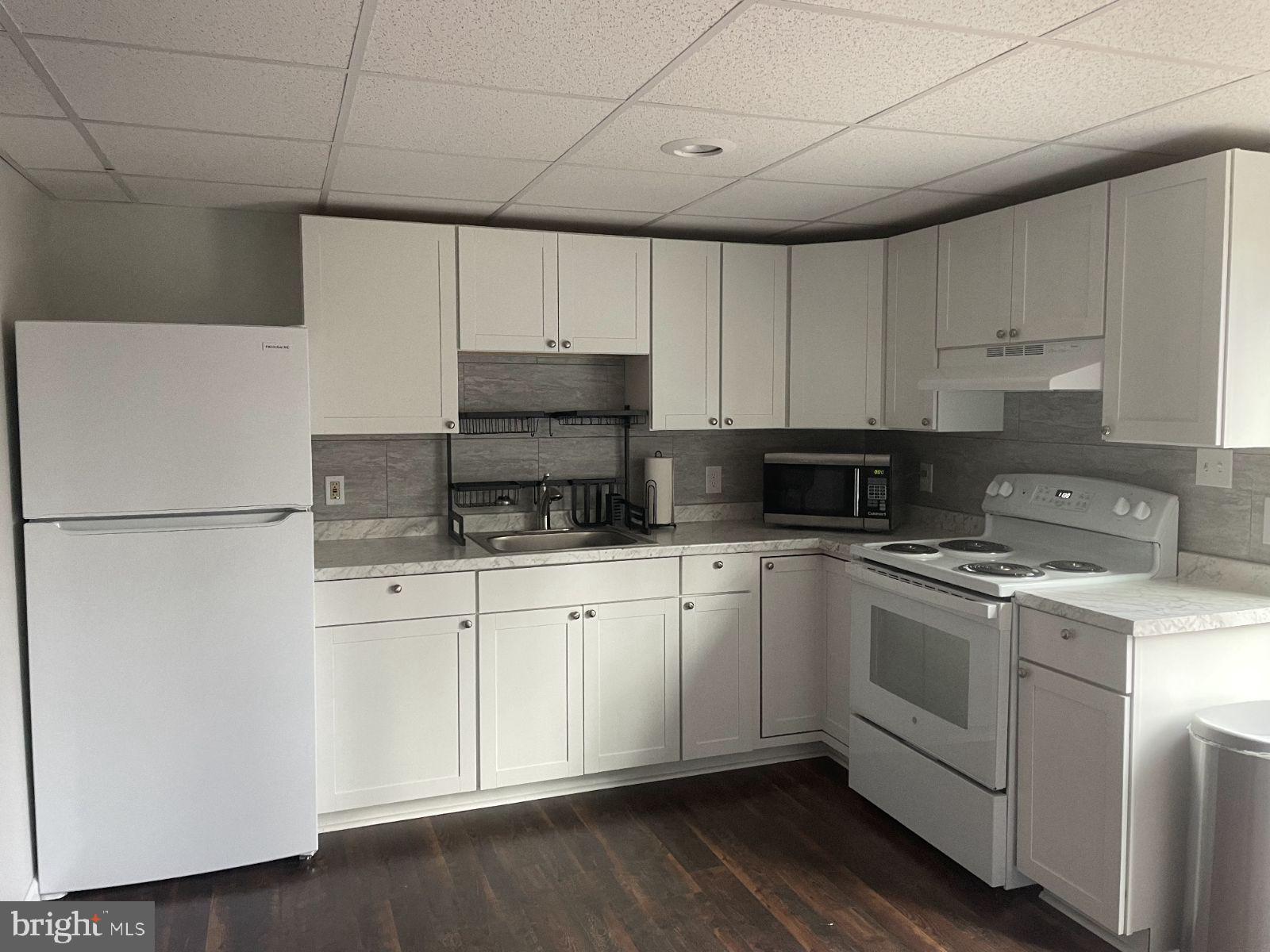 12632 Western Circle Lusby, MD 20657 - Photo 2 of 8 a kitchen with stainless steel appliances granite countertop a stove a sink and a refrigerator