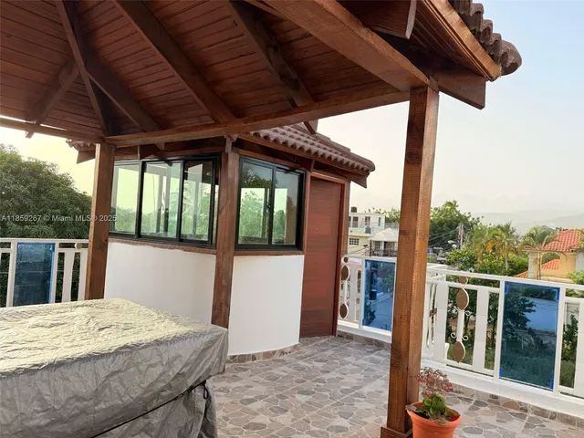 a view of a patio with a table and chairs under an umbrella