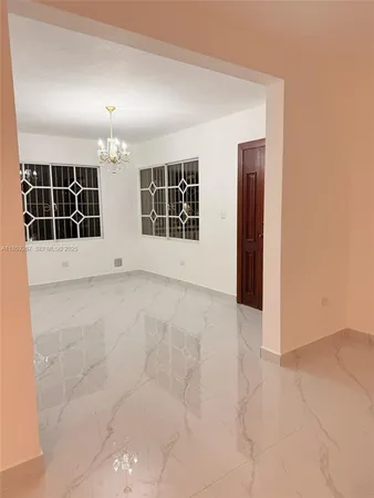 an empty room with windows and pillars in it