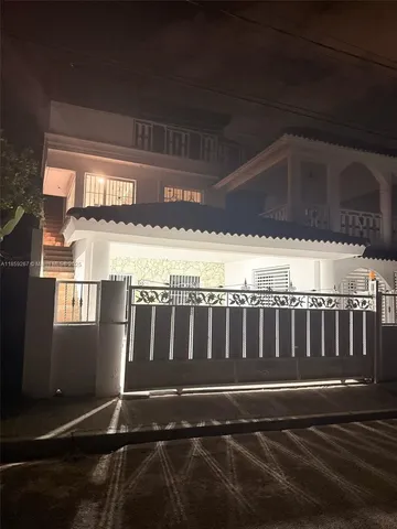 a view of kitchen with furniture and refrigerator