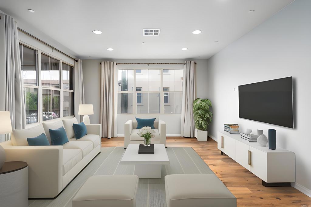 a living room with furniture flat screen tv and a large window