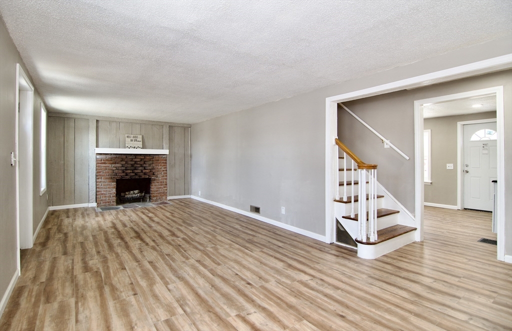 511 Parker Street Springfield, MA 01129 - Photo 11 of 41 a view of a livingroom with wooden floor and a fireplace