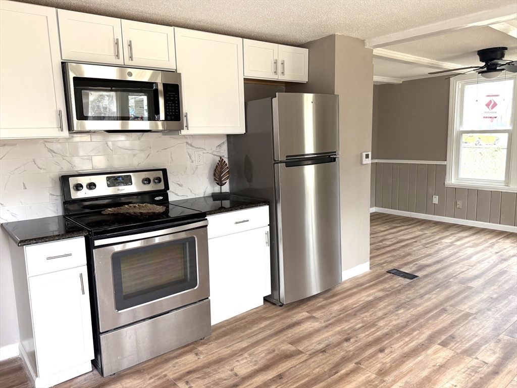 511 Parker Street Springfield, MA 01129 - Photo 5 of 41 a kitchen with a refrigerator stove and microwave
